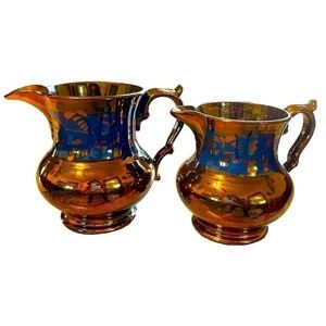 2 Antique copper lusterware pitchers, one slightly larger than the other